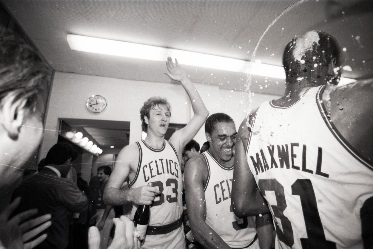 Boston Celtics players Larry Bird and Dennis Johnson celebrate the team's NBA championship in 1984.