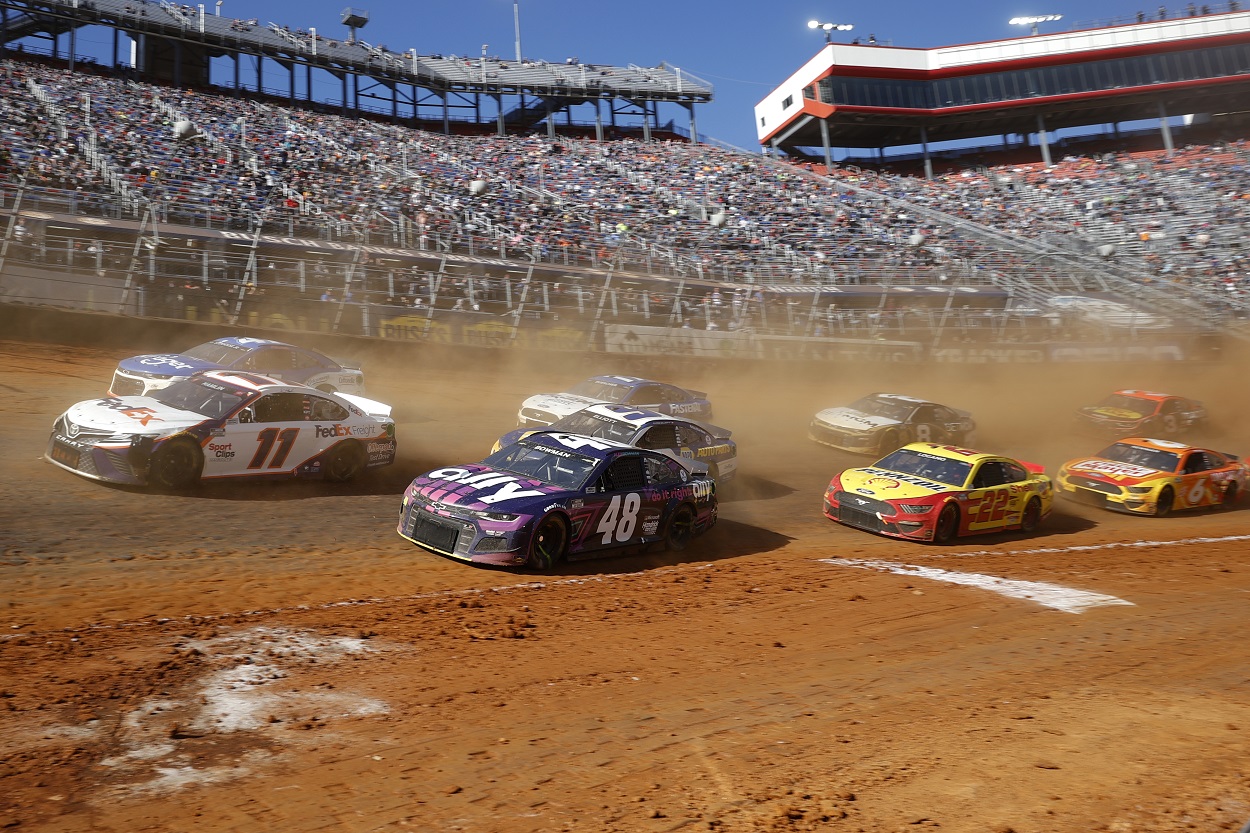 Denny Hamlin leads a pack of cars during the NASCAR Cup Series Food City Dirt Race at Bristol Motor Speedway on March 29, 2021 | Chris Graythen/Getty Images
