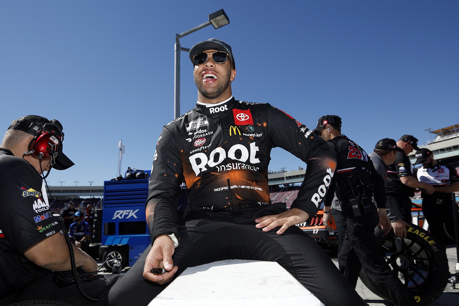 Bubba Wallace speaks with crew members on the grid during practice for for the Ruoff Mortgage 500 at Phoenix Raceway on March 12, 2022.