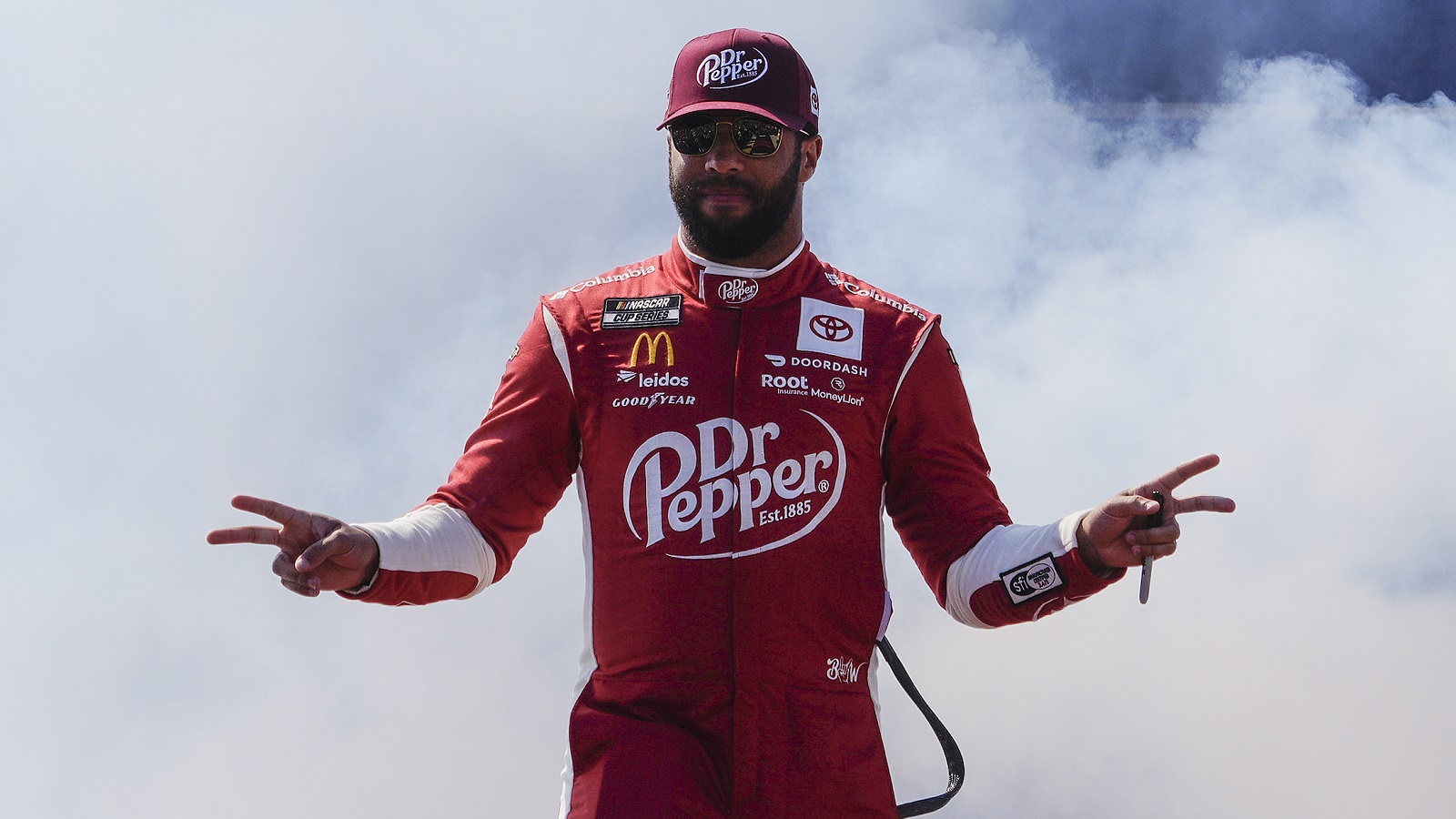 Bubba Wallace waves to fans onstage during driver intros prior to the NASCAR Cup Series Toyota Owners 400 at Richmond Raceway on April 3, 2022,