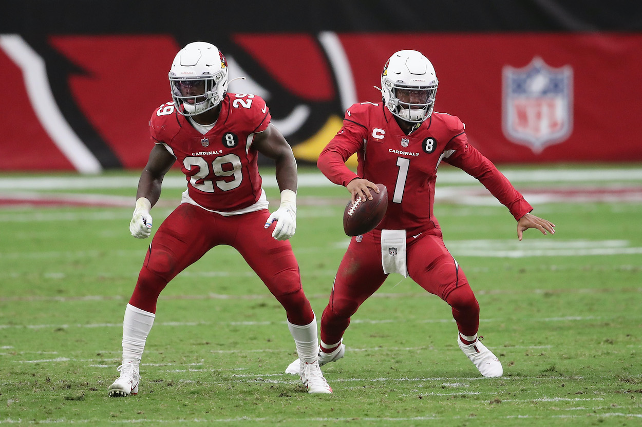 Quarterback Kyler Murray of the Arizona Cardinals scrambles with the football alongside running back and now former teammate Chase Edmonds