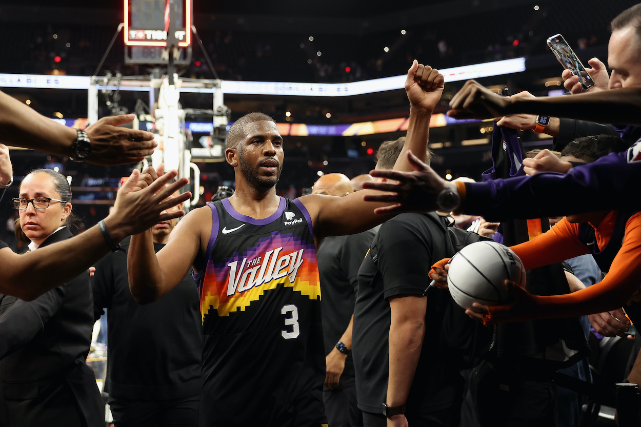 Chris Paul high fives fans on his way off the court.