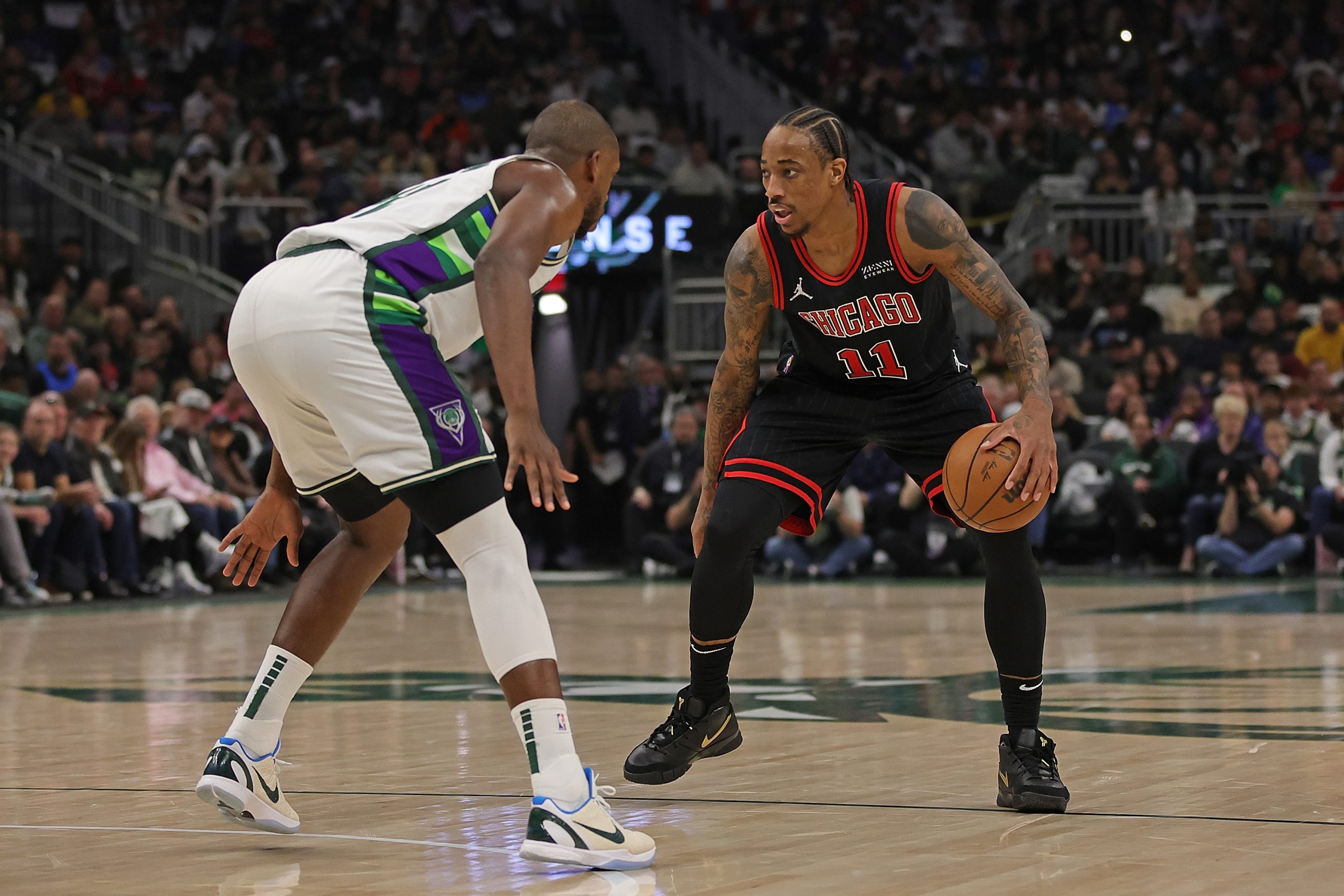 DeMar DeRozan of the Chicago Bulls is defended by Khris Middleton of the Milwaukee Bucks.