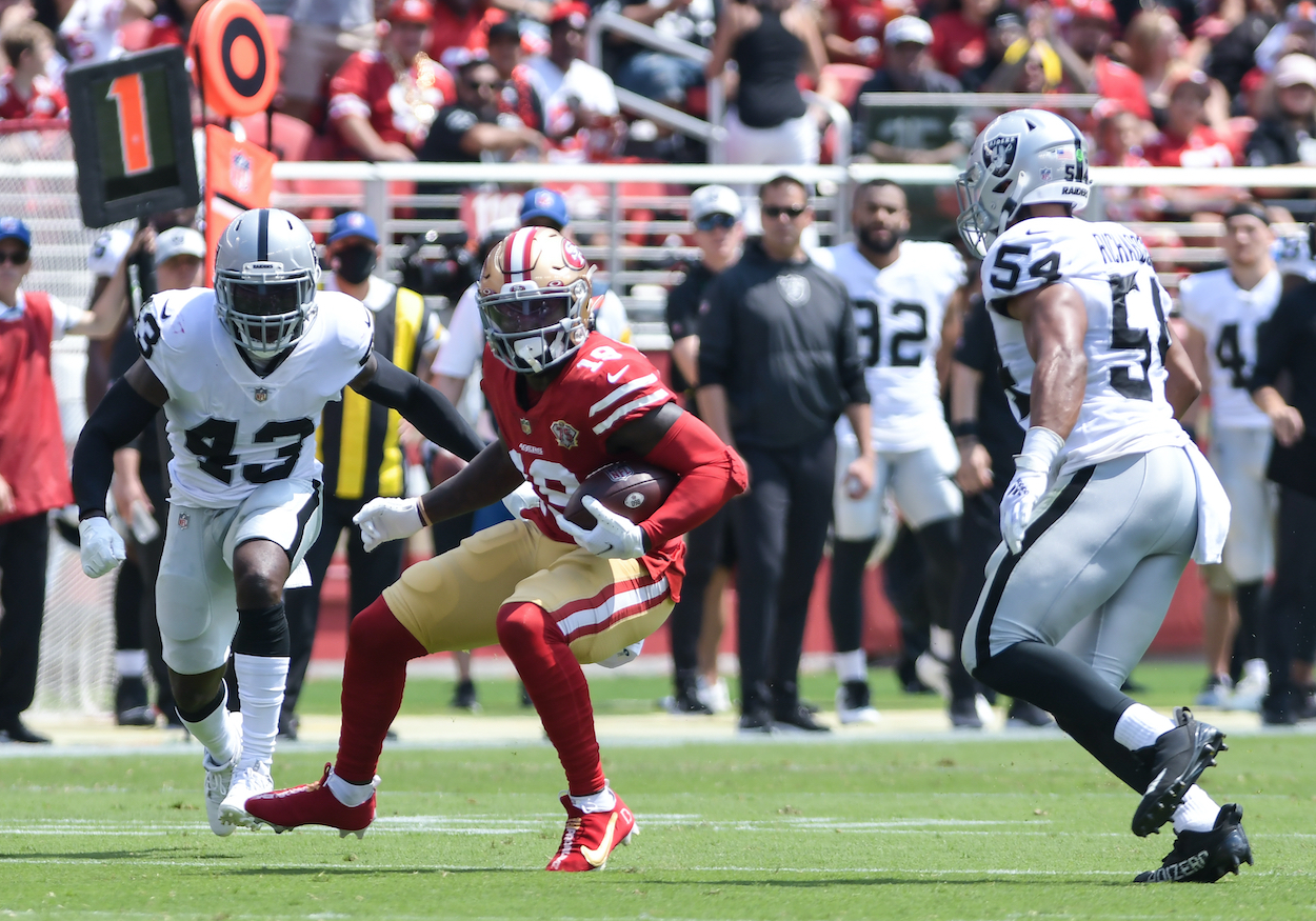 San Francisco 49ers wide receiver Deebo Samuel is trapped between Las Vegas Raiders players.