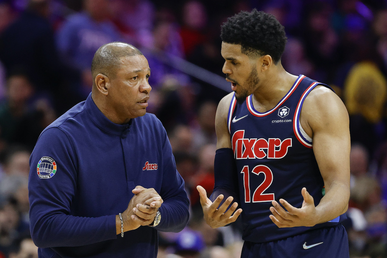 Doc Rivers and Tobias Harris talk during a game.