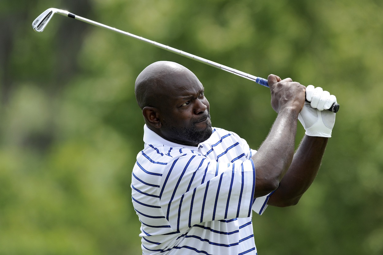 Emmitt Smith hits a golf shot.