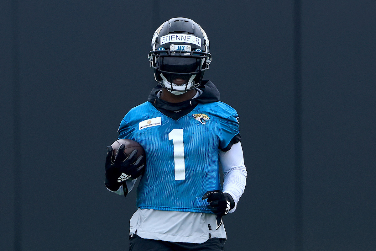 Jacksonville Jaguars running back Travis Etienne Jr. runs with the football during mandatory minicamp