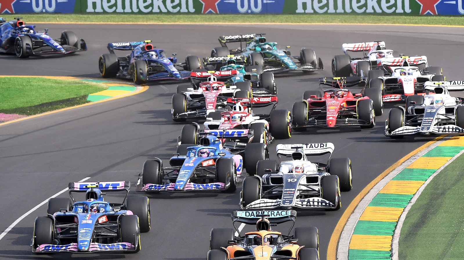 Formula 1 cars negotiate a corner at the start of the 2022 Australian Grand Prix at the Albert Park Circuit in Melbourne on April 10, 2022.