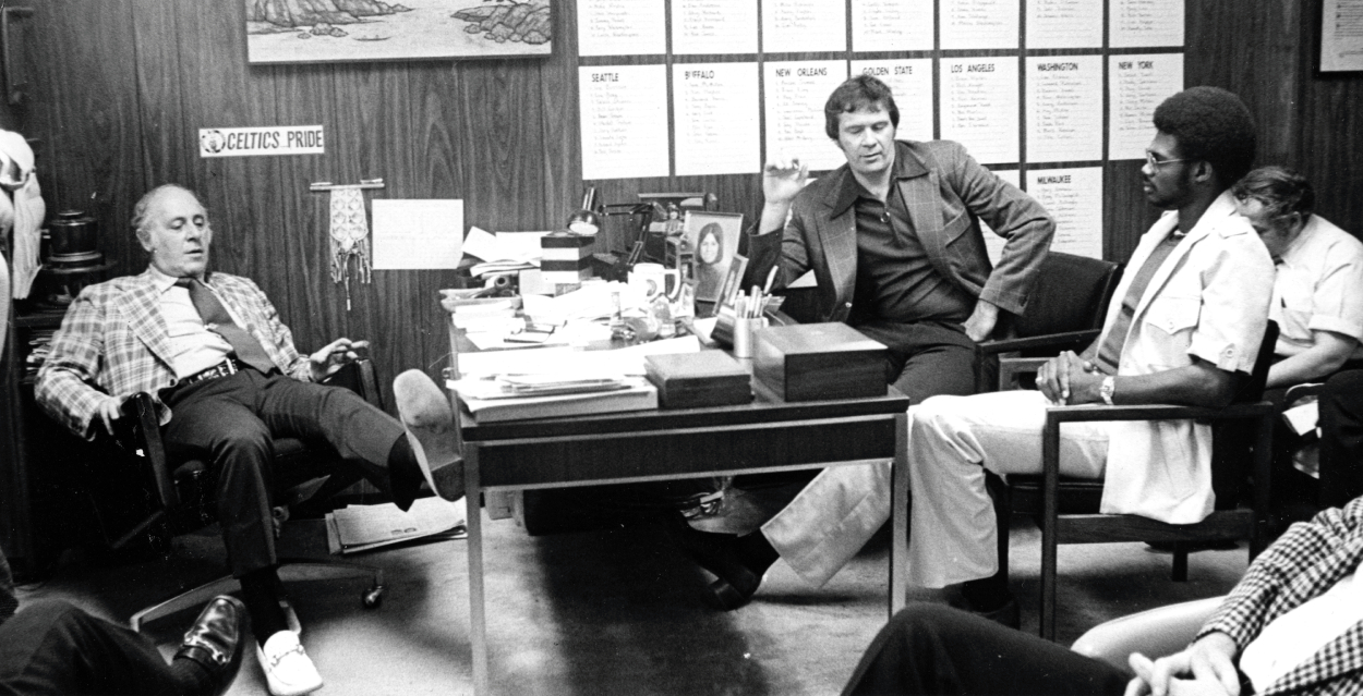 From left, Boston Celtics president and general manager Red Auerbach and head coach Tom Heinsohn sit with draft pick Glenn McDonald on June 5, 1974.