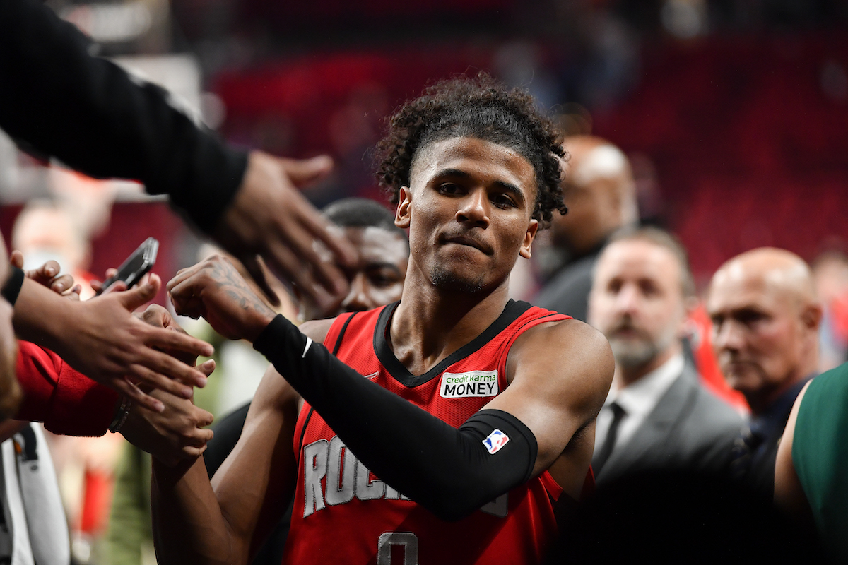 Jalen Green of the Houston Rockets shakes hands with fans after a game