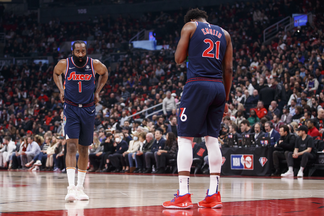 James Harden stands alongside Joel Embiid.