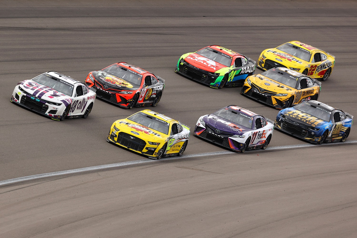 Ryan Blaney, Alex Bowman, and Joe Gibbs Racing's Martin Triex Jr. and Denny Hamlin lead the way during the NASCAR Cup Series Pennzoil 400 at Las Vegas Motor Speedway on March 6, 2022.