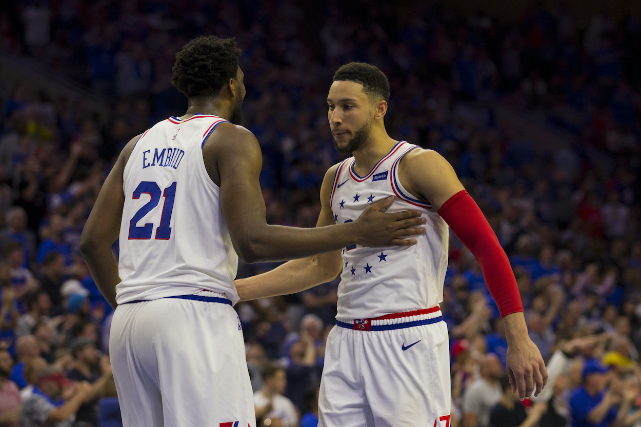 Joel Embiid and Ben Simmons celebrate during a game.