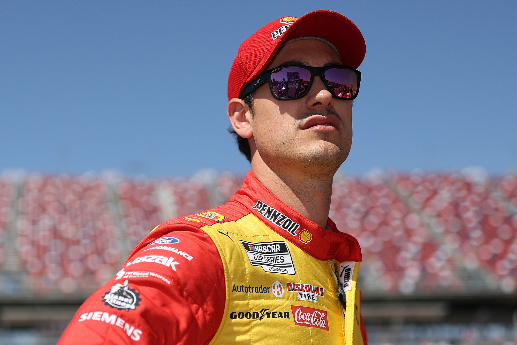 Joey Logano looks on before qualifying