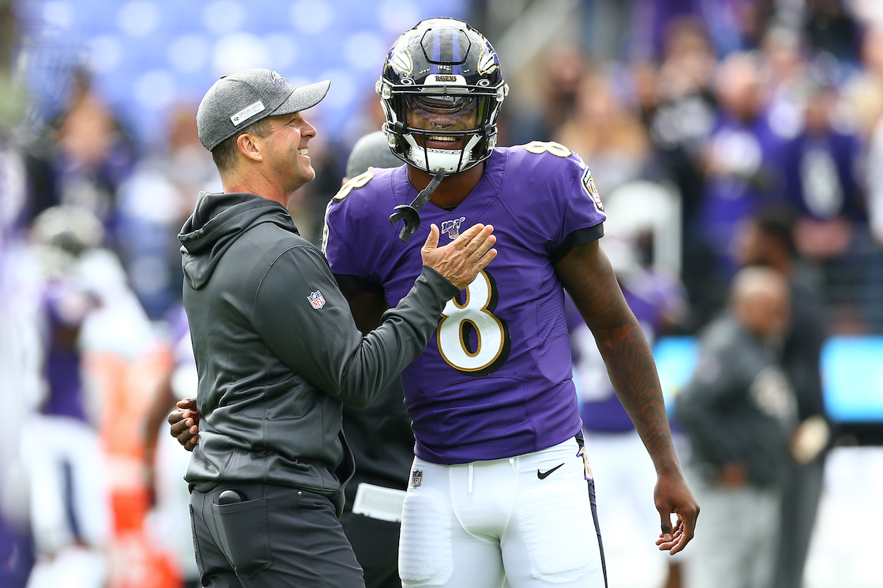 Head coach John Harbaugh interacts with Lamar Jackson of the Baltimore Ravens. The coach recently gave an update on the QB's contract status.
