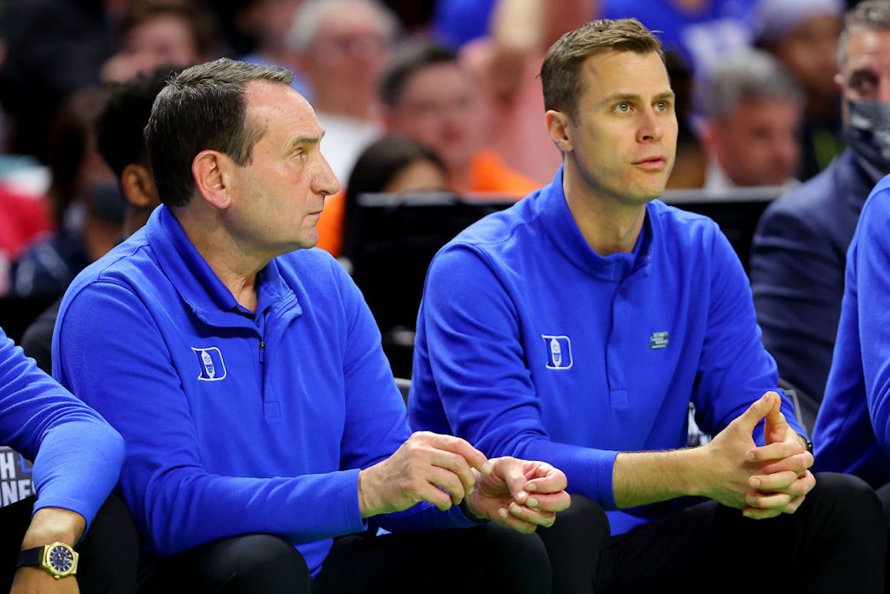 Jon Scheyer (R) sits on the bench with Mike Krzyzewski (L) on the Duke bench.