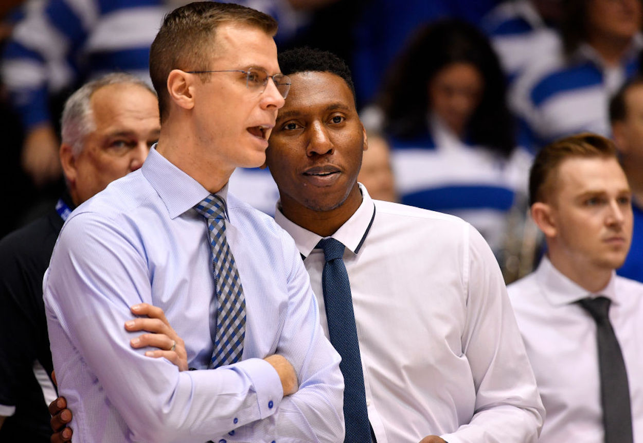 Jon Scheyer (L) and Nolan Smith (R) in conversation before a Duke Blue Devils game.