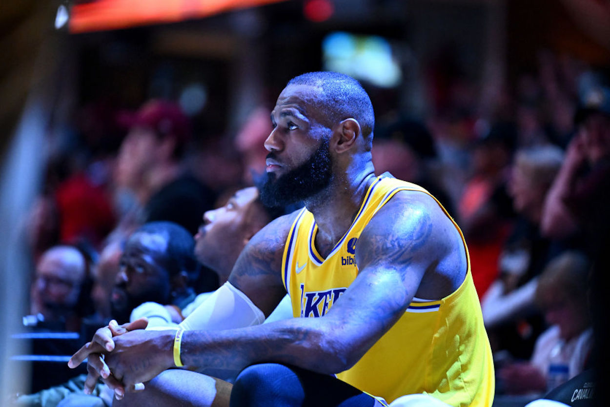 Lakers star LeBron James sits on the bench.