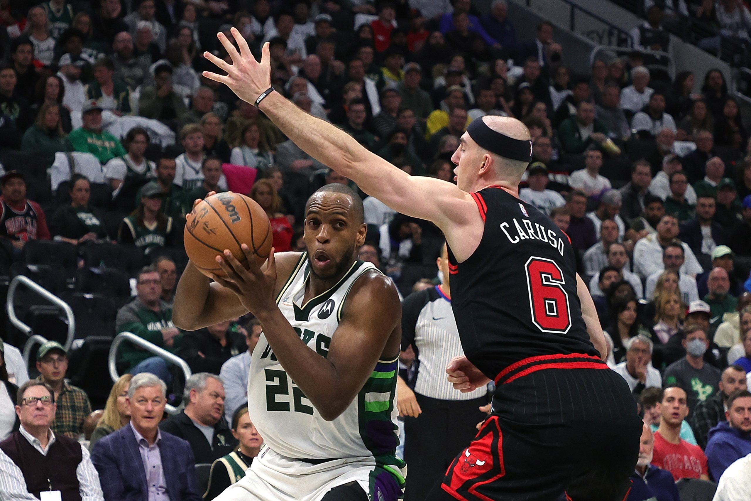 Khris Middleton of the Milwaukee Bucks is defended by Alex Caruso of the Chicago Bulls.
