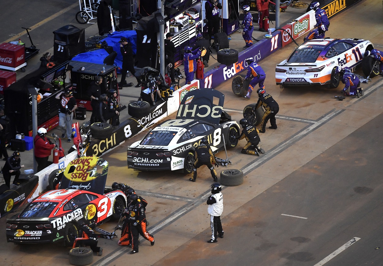 Austin Dillon, Tyler Reddick, and Denny Hamlin pit during the 2022 NASCAR Cup Series Food City Dirt Race at Bristol Motor Speedway