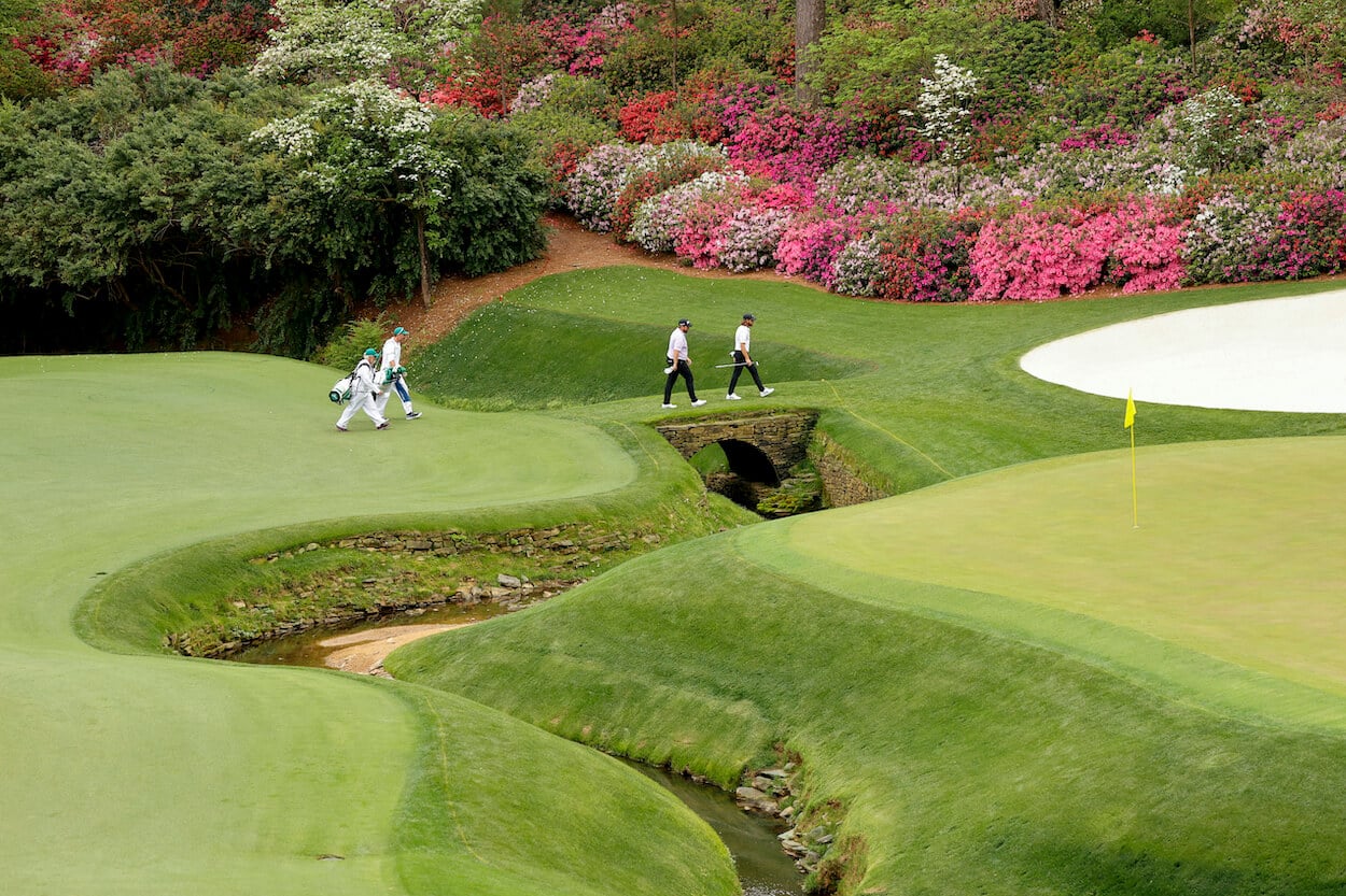 Tommy Fleetwood and Shane Lowry walk across Rae's Creek.