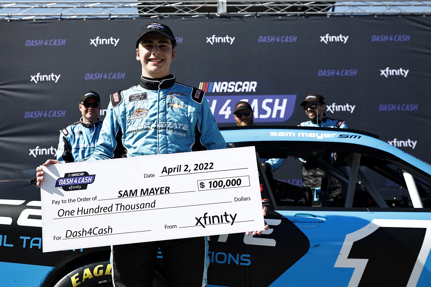 Sam Mayer poses with the Dash 4 Cash check after the NASCAR Xfinity Series ToyotaCare 250 at Richmond Raceway on April 2, 2022.