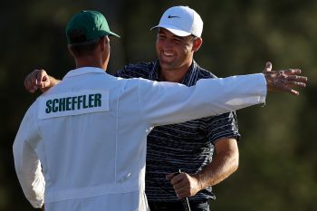 Scottie Scheffler prepares to embrace his caddie at the Masters