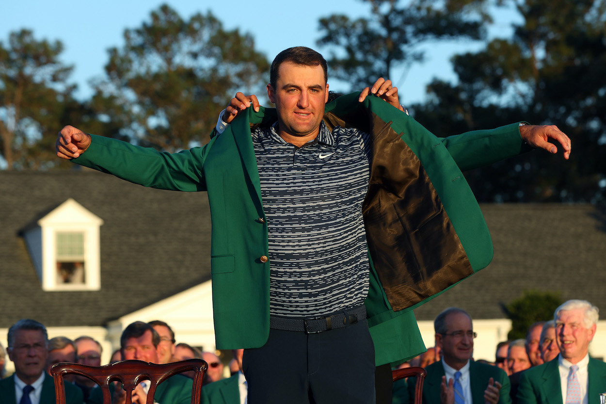 Scottie Scheffler is awarded the Green Jacket by 2021 Masters champion Hideki Matsuyama.