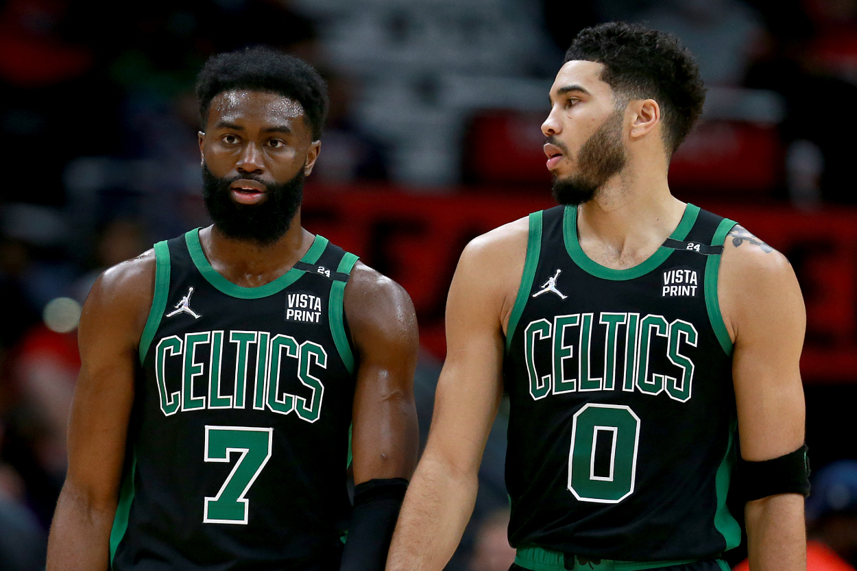 Jaylen Brown #7 of the Boston Celtics and Jayson Tatum stand on the court.