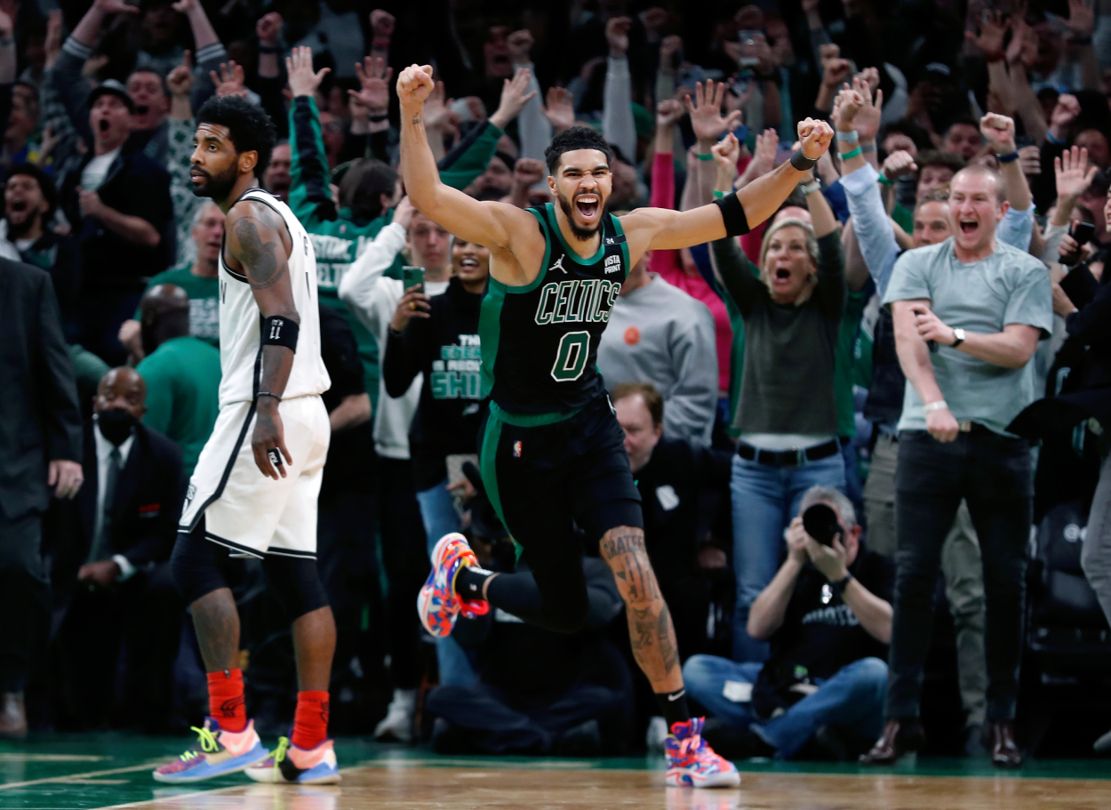 Jayson Tatum (right) celebrates as the fans erupt after his basket at the buzzer.