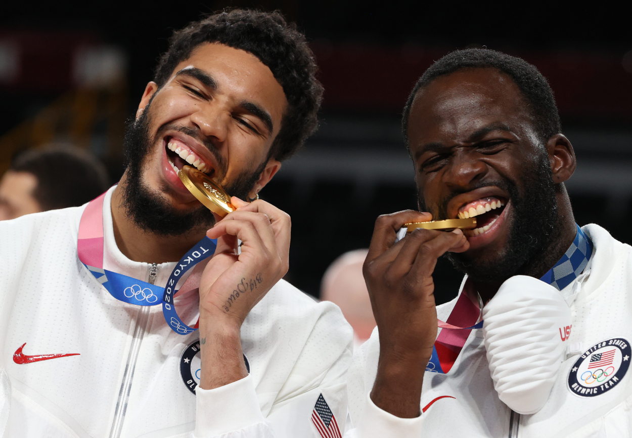 Jayson Tatum and Draymond Green of Team USA pose for photographs with their gold medals.
