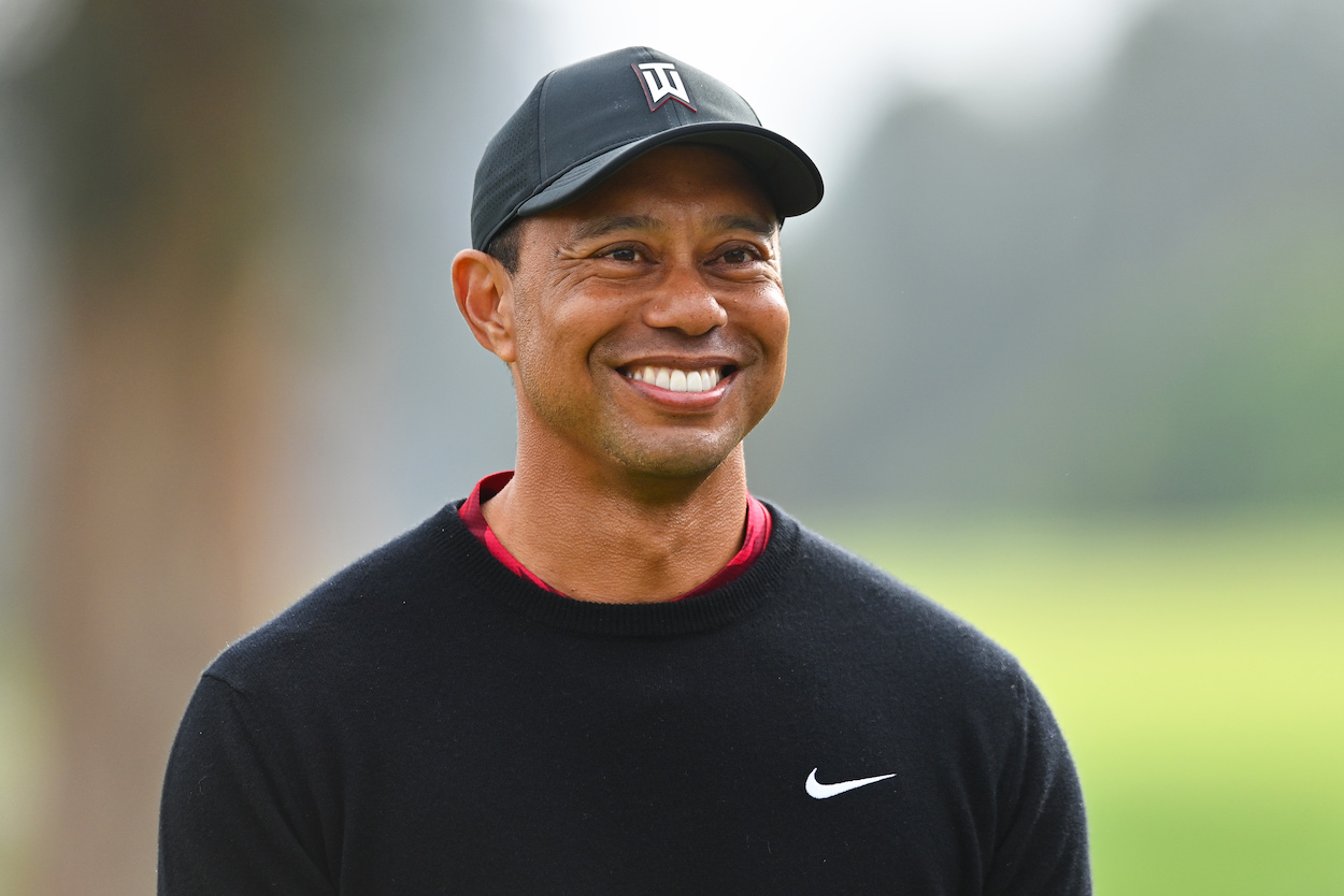 Tiger Woods smiles on the course.