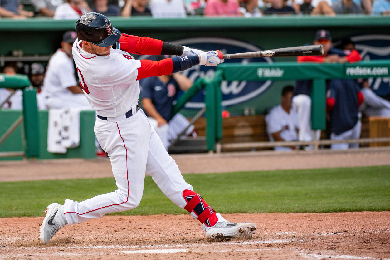 Trevor Story of the Boston Red Sox hits a single during the fourth inning of his Boston Red Sox Spring Training Grapefruit League debut.