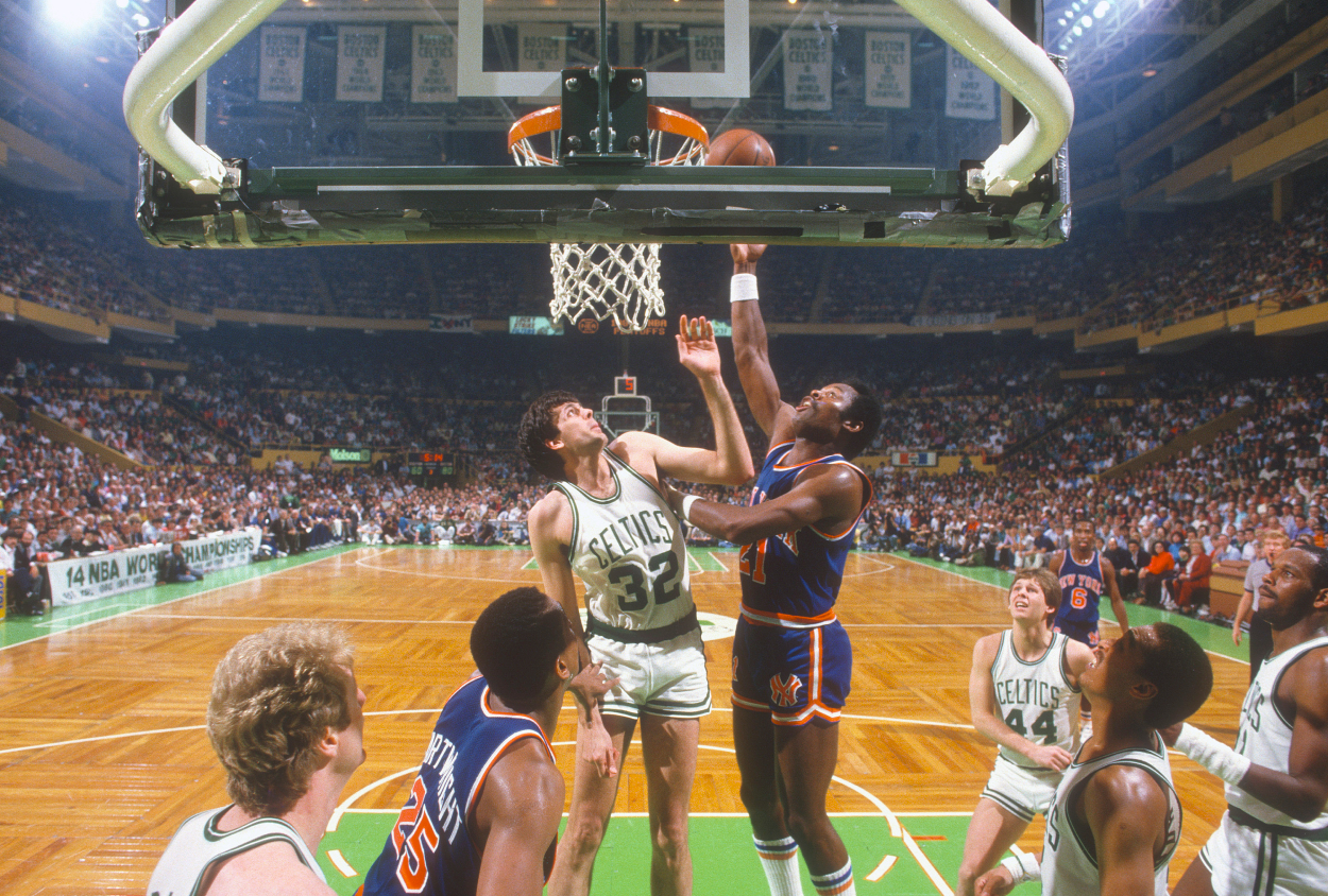 Truck Robinson of the New York Knicks shoots over Kevin McHale of the Boston Celtics.
