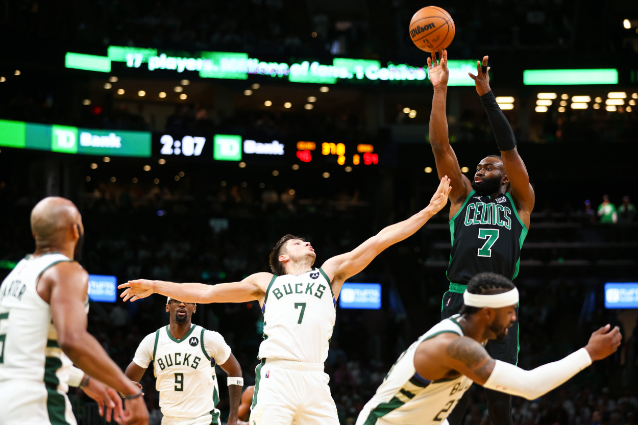 Jaylen Brown of the Boston Celtics shoots the ball while guarded by Grayson Allen of the Milwaukee Bucks.