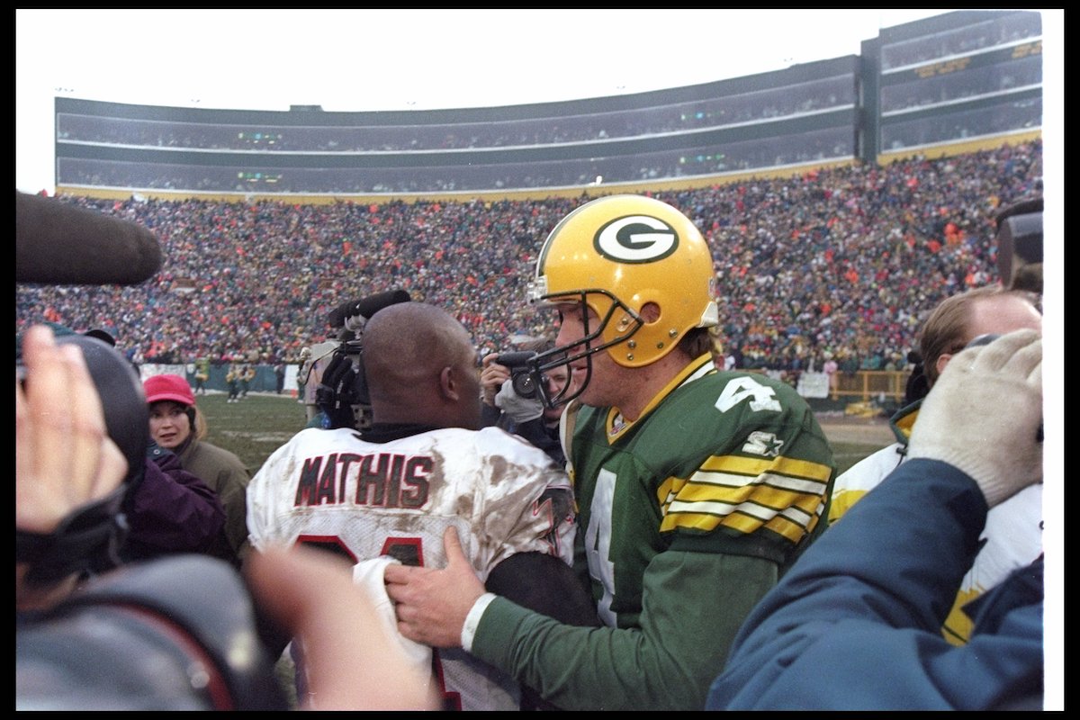 Quarterback Brett Favre of the Green Bay Packers and Atlanta Falcons wide receiver Terance Mathis confer after a playoff game at Lambeau Field