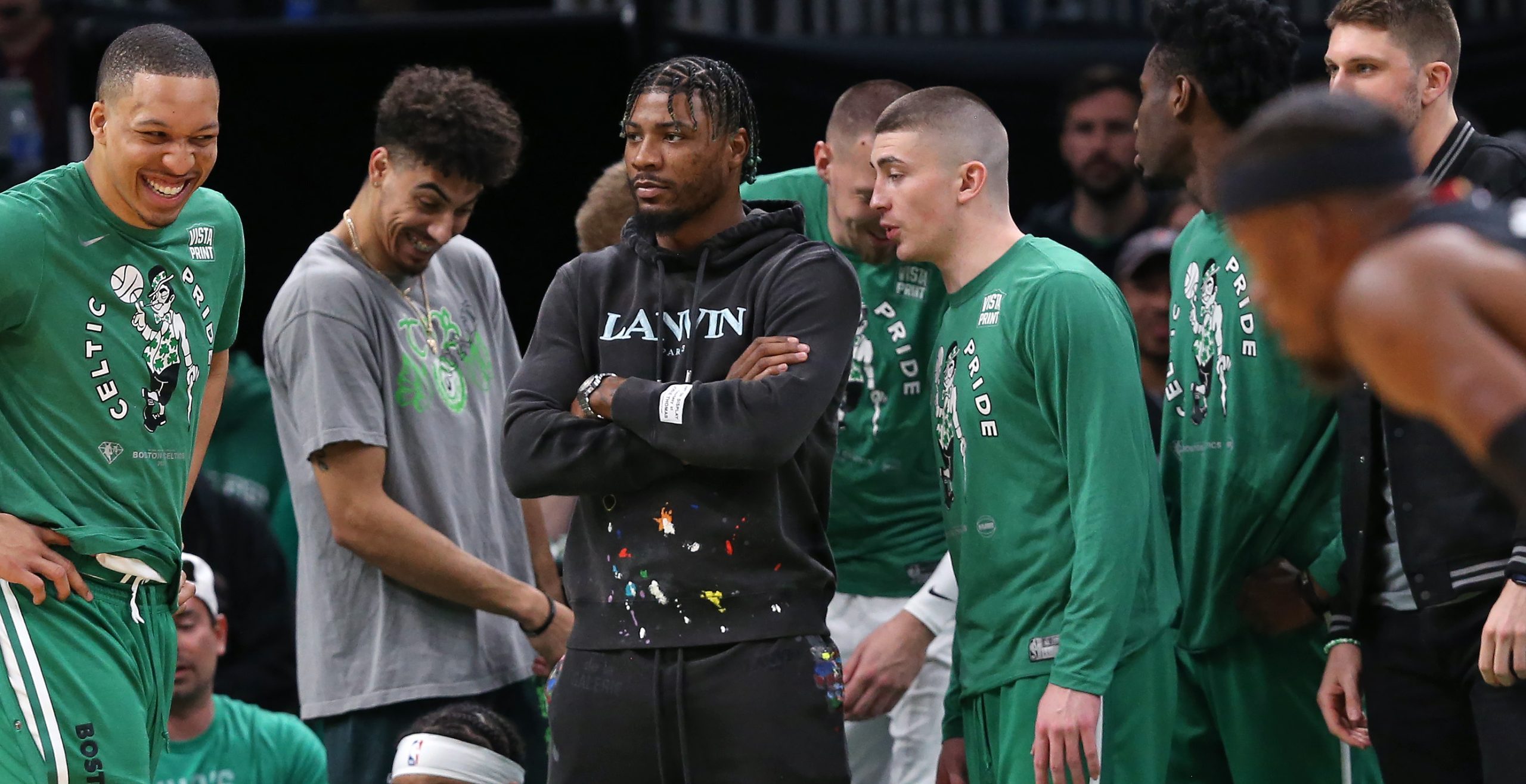 Marcus Smart is pictured in street clothes on the sideline in the first quarter as the Boston Celtics hosted the Miami Heat.