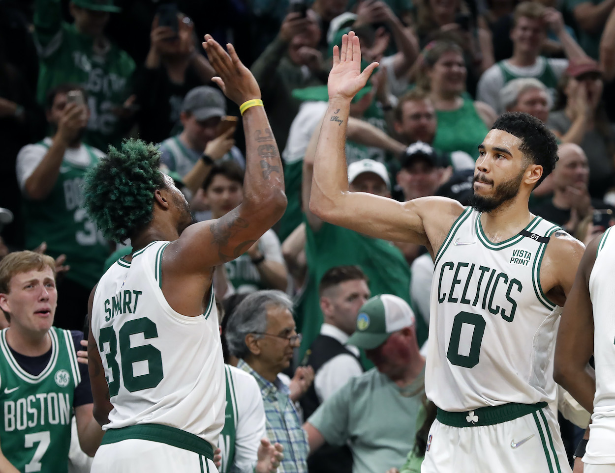 Marcus Smart and Jayson Tatum celebrate after Game 7 against the Bucks.