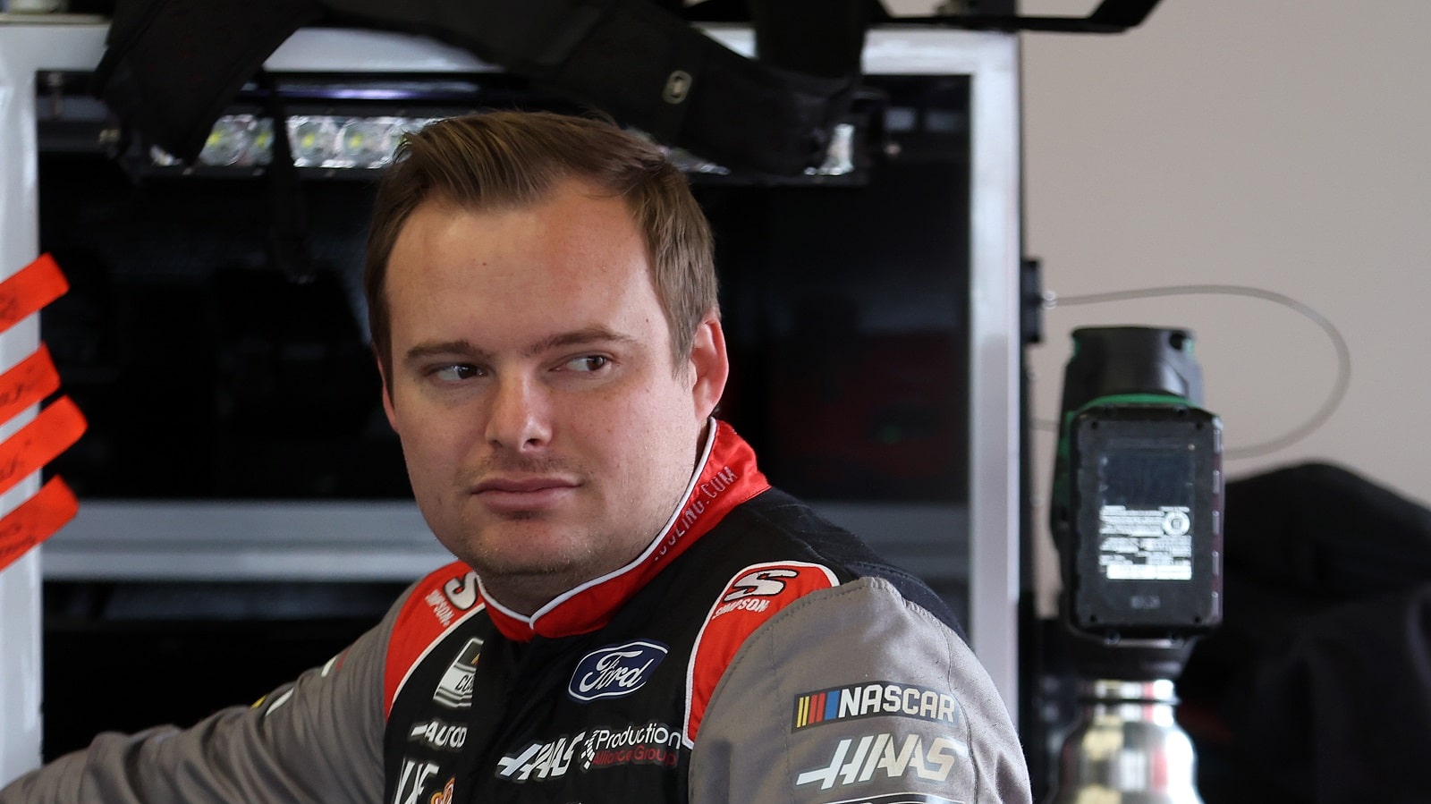 Cole Custer waits in the garage area during practice for the NASCAR Cup Series Daytona 500 at Daytona International Speedway on Feb. 18, 2022.