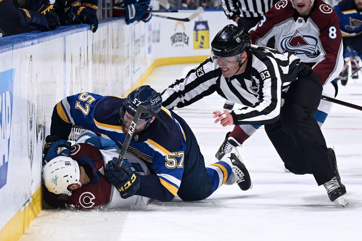 David Perron (57) takes down Avalanche forward Nazem Kadri.