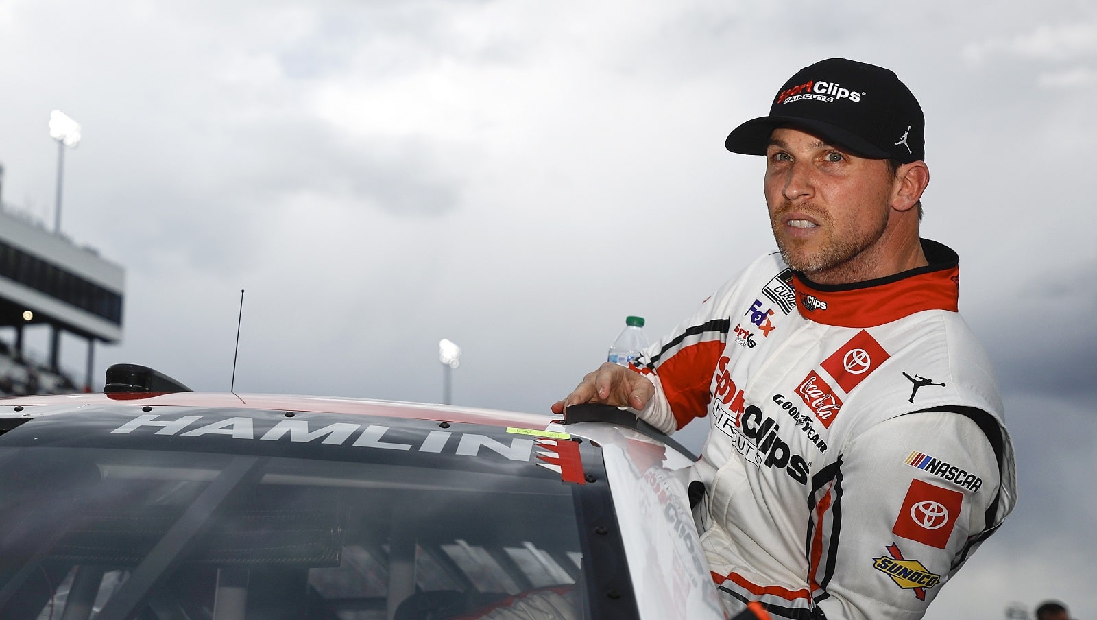 Denny Hamlin, driver of the No. 11 Toyota, enters his car during qualifying for the NASCAR Cup Series Blue-Emu Maximum Pain Relief 400 at Martinsville Speedway on April 8, 2022. | Jared C. Tilton/Getty Images