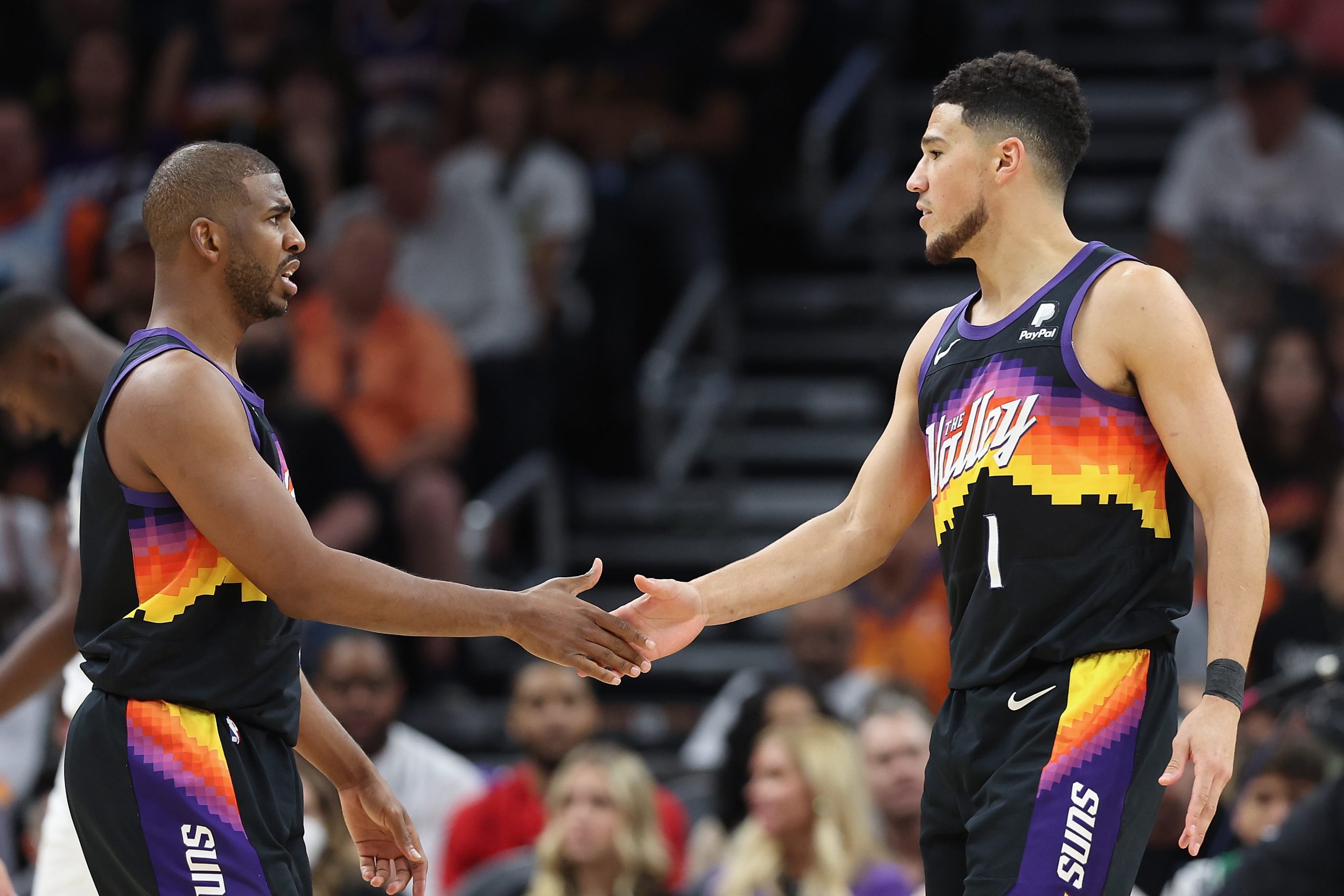 Chris Paul, left,and Devin Booker of the Phoenix Suns shake hands during the second half.