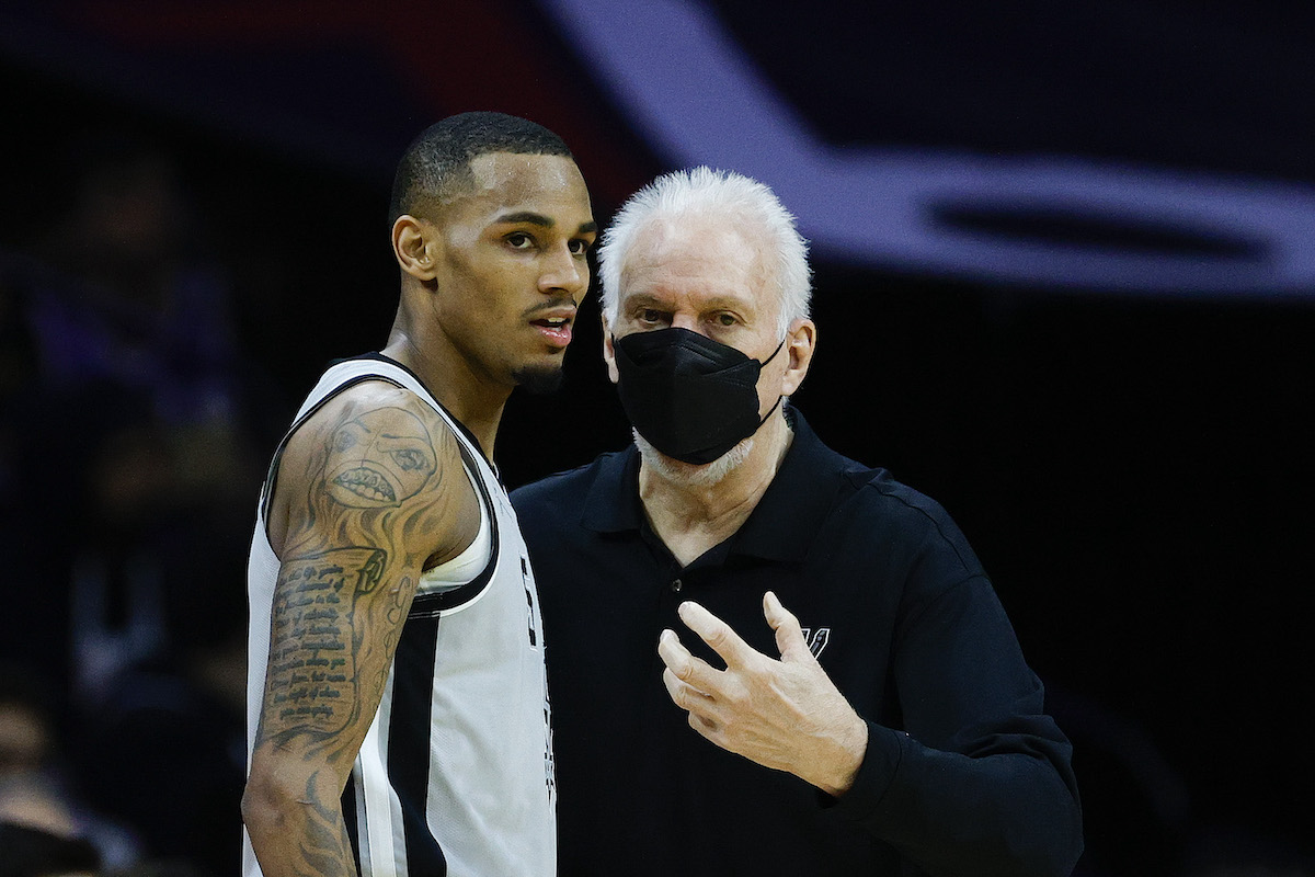 Head coach Gregg Popovich of the San Antonio Spurs speaks to Dejounte Murray during the third quarter against the Philadelphia 76ers