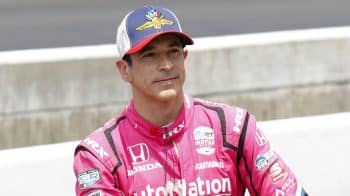 IndyCar driver Helio Castroneves poses for a photo with his car on May 21, 2022, after qualifying for the 106th running of the Indianapolis 500 at the Indianapolis Motor Speedway.