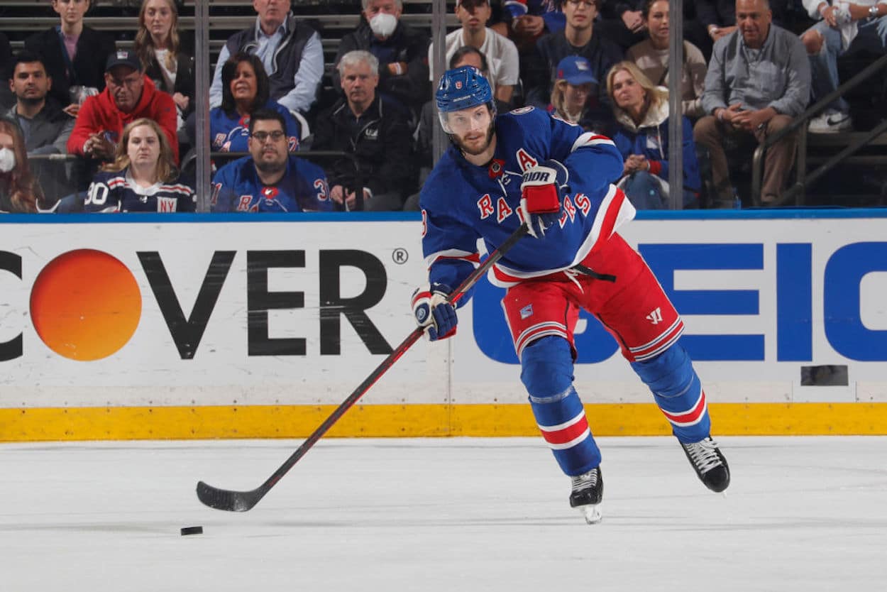 New York Rangers defenseman Jacob Trouba carries the puck up ice.