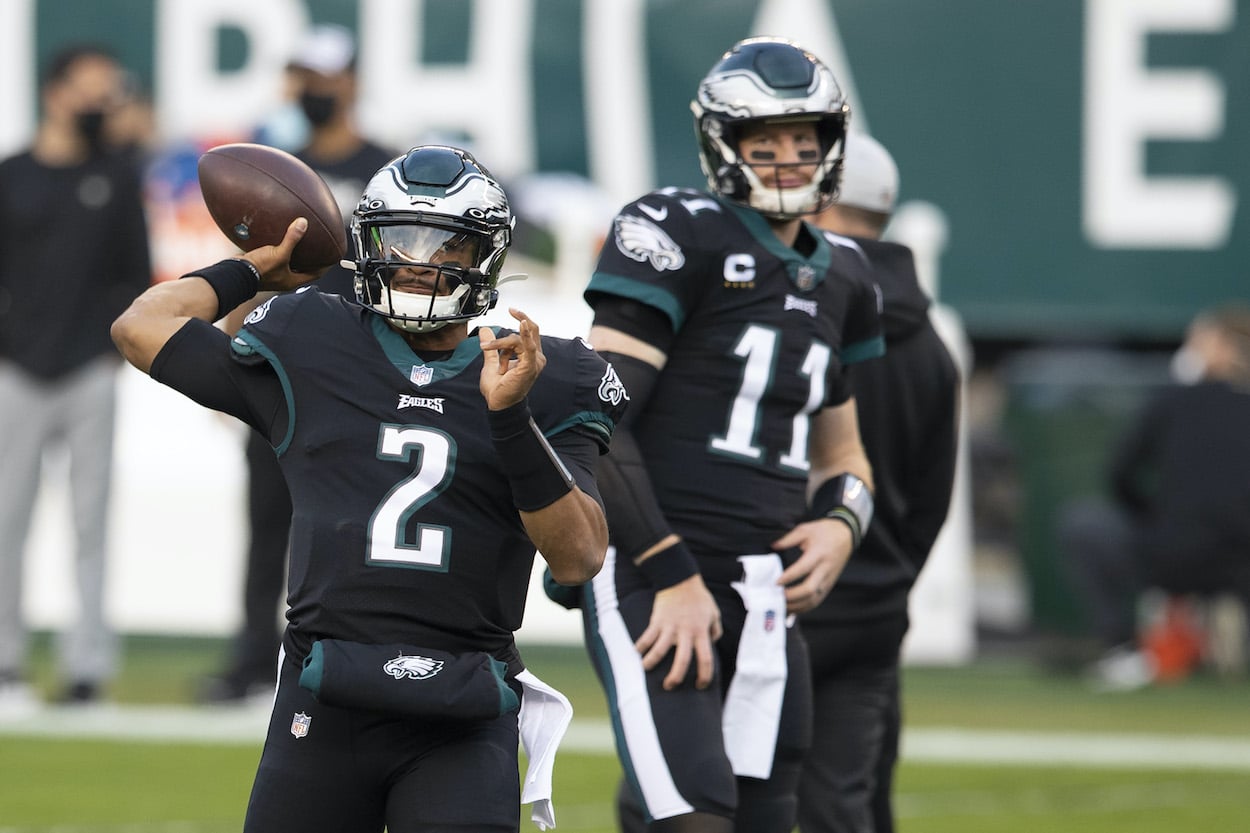 Jalen Hurts and Carson Wentz warm up before a game.