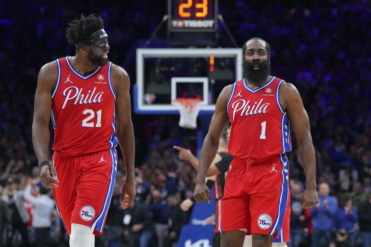 Joel Embiid and James Harden look on against the Heat.