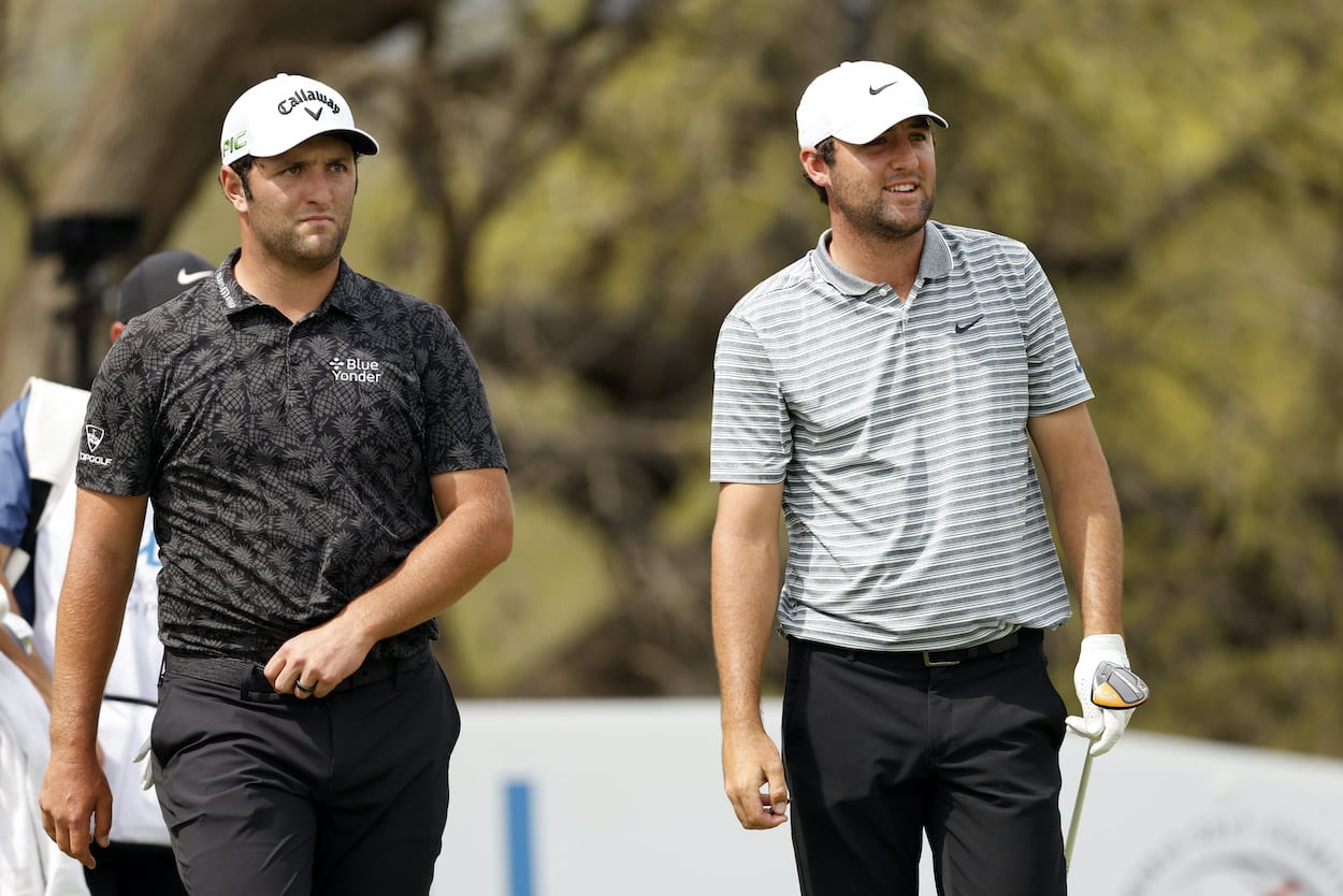 Jon Rahm and Scottie Scheffler walk off the tee.