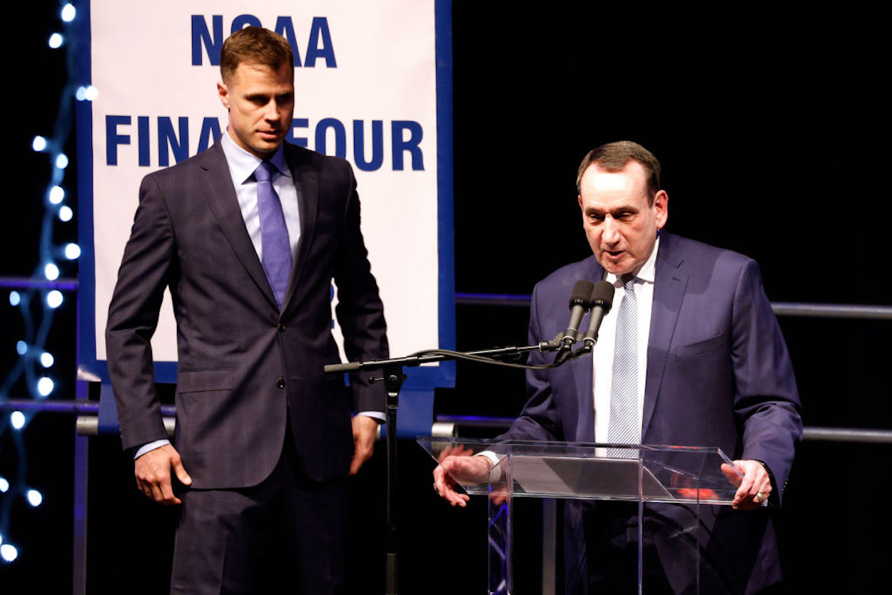 Jon Scheyer (L) looks on as Mike Krzyzewski (R) speaks.