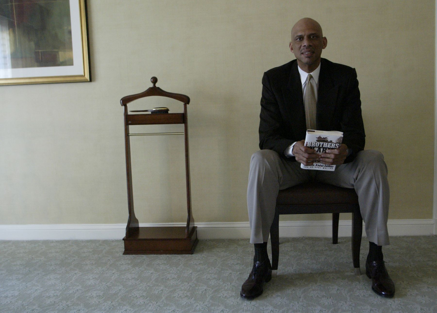 Kareem Abdul-Jabbar in Washington D.C. holding his book 'Brother in Arms' about his father's experiences in World War II
